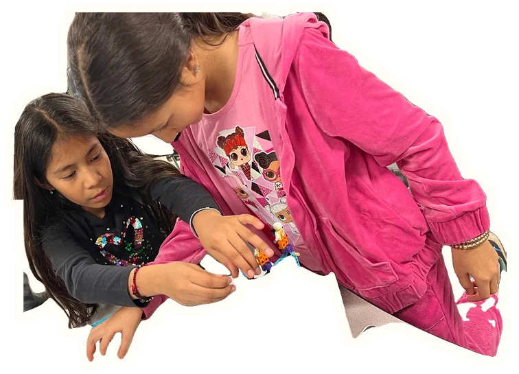 Two createMPLS students build a LEGO simple machine together.