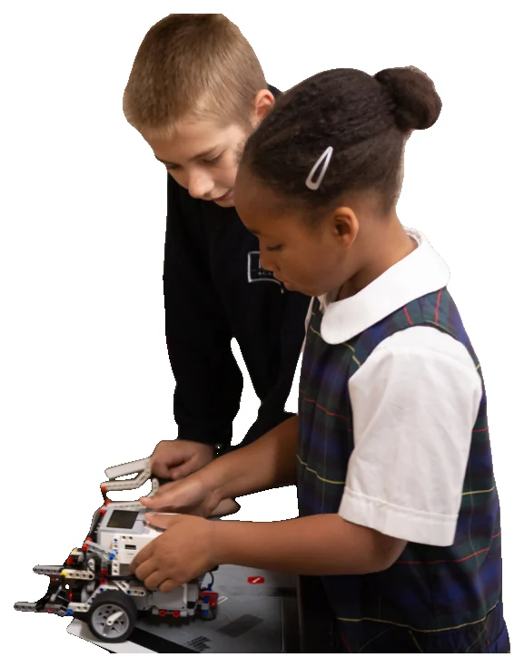 Two createMPLS students lean in together to adjust the LEGO robot they built.