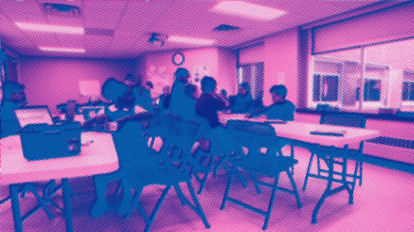 Students building and programming LEGO robots in small teams in a bright Minneapolis classroom.