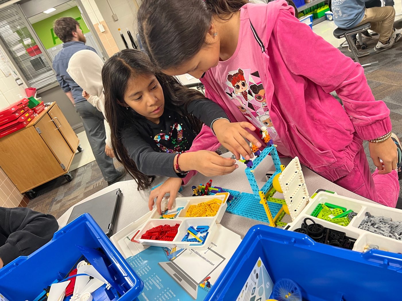 Two students build a LEGO simple machine